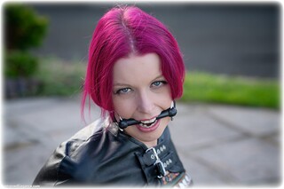 Bondage photo pic picture Temptress Kate armbinder, satin, handcuffs, bit gag, silk, single glove, leg irons, metal bondage, outdoor, redhead