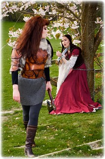Bondage photo pic picture Sophia Smith and Zoe Page girlgirl, boots, brunette, lesbian, chains, medieval, metal bondage, outdoor, dress, ungagged, fiddle, redhead