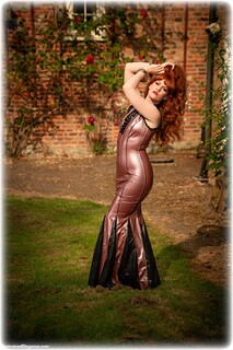 Bondage photo pic picture Zoe Page barefoot, bit gag, handcuffs, latex, leg irons, metal bondage, ungagged, redhead
