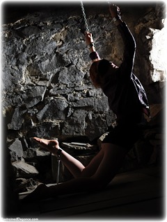 Bondage photo pic picture Anita deBauch barefoot, scarf bondage, skirt, sm factory, leg irons, chains, spreader bar, metal bondage, corset, dungeon, ungagged, redhead