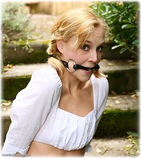 Bondage photo pic picture Ariel Anderssen barefoot, handcuffs, bit gag, blouse, metal bondage