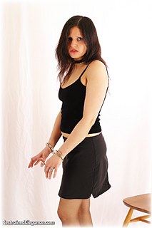 Bondage photo pic picture Debbie A handcuffs, skirt, leg irons, metal bondage, pantyhose, ungagged
