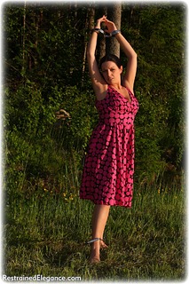 Bondage photo pic picture Temptress Kate barefoot, handcuffs, brunette, leg irons, metal bondage, outdoor, dress, ungagged