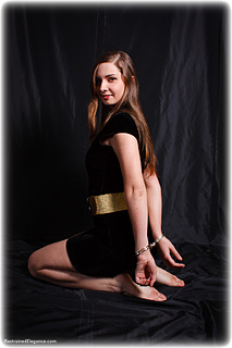 Bondage photo pic picture Zarina barefoot, handcuffs, hogtie, leg irons, chains, cloth gag, thumbcuffs, dress, gag